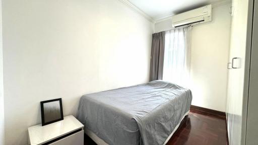 Bright and minimalistic bedroom with air conditioning and hardwood floors