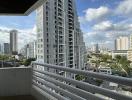 Spacious balcony with urban skyline and clear skies