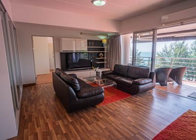 Spacious living room with large windows and balcony access