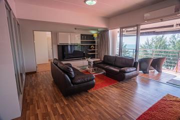 Spacious living room with large windows and balcony access