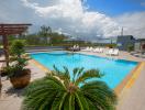 Spacious outdoor swimming pool with lounge chairs and beautiful sky view