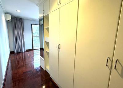 Spacious bedroom with built-in wardrobe and hardwood flooring