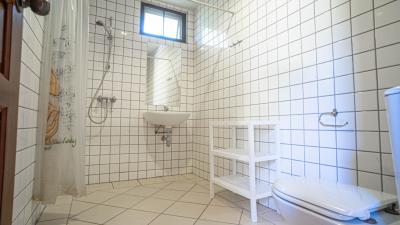Bright tiled bathroom with a small window