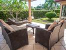 Spacious and well-appointed patio area with comfortable seating and lush garden views