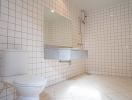 Spacious bathroom with wall-mounted sink and tiled walls