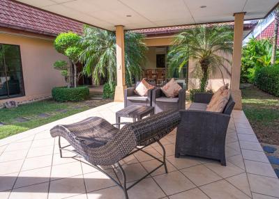Spacious patio with outdoor furniture and landscaped garden