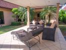 Spacious patio with outdoor furniture and landscaped garden