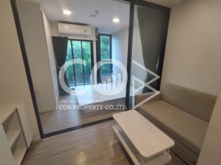 Cozy bedroom with modern furniture and sliding glass door leading to a balcony