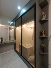 Modern bathroom with glass shower enclosure and elegant shelving