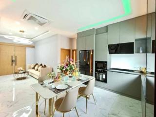 Modern kitchen with dining area, stainless steel appliances, and a bouquet on the table