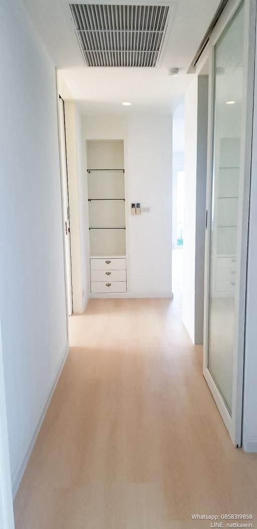 Bright corridor with modern white storage cabinets