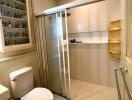 Clean and modern bathroom with glass shower enclosure