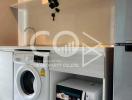 Modern kitchen with white washing machine and microwave