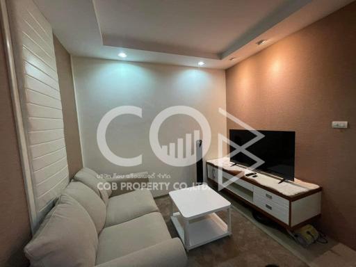 Cozy living room with comfortable sofa and modern entertainment unit