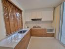 Modern kitchen with natural light and wooden blinds