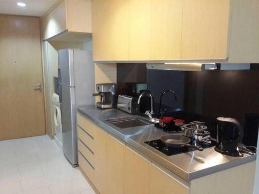 Modern kitchen with stainless steel appliances and wooden cabinets