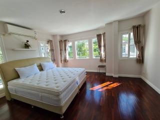 Spacious bedroom with large bed and hardwood floors