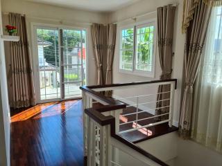 Cozy bedroom with ample natural light and balcony access