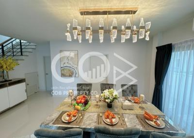 Modern dining room with a large table and stylish lighting fixtures