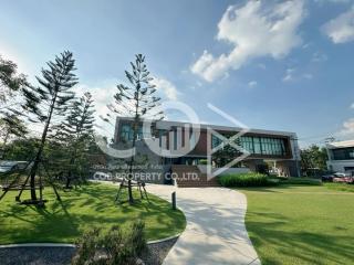 Modern two-story building exterior with landscaped garden