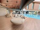 Modern building interior with hanging chair and pool view