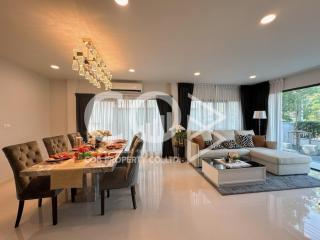 Spacious and well-lit combined living and dining area with modern furnishings and large windows