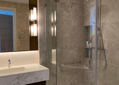 Modern bathroom with glass shower and marble tiles