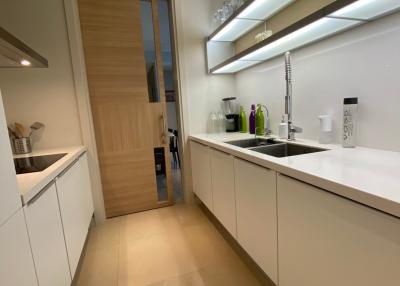 Modern kitchen with light wood cabinets and stainless steel fixtures