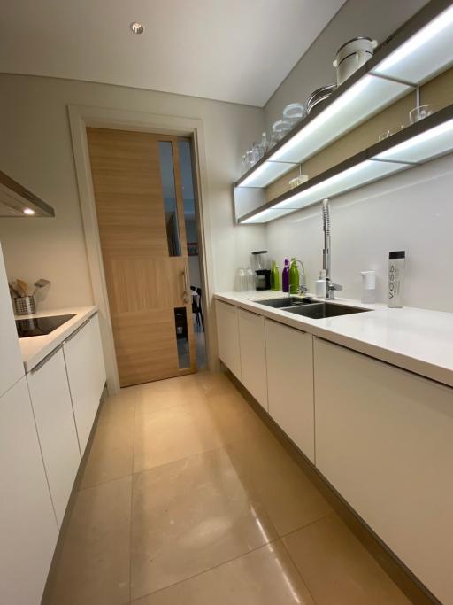 Modern kitchen with light wood cabinets and stainless steel fixtures