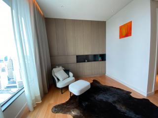 Modern living room with city view, a lounge chair, and wooden paneling