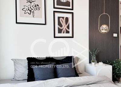 Modern bedroom interior with decorative wall art and plants
