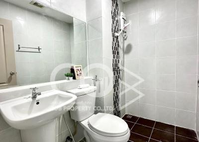 Modern bathroom with white tiling and fixtures