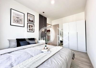 Modern bedroom interior with wooden accents, white walls, and sophisticated decor