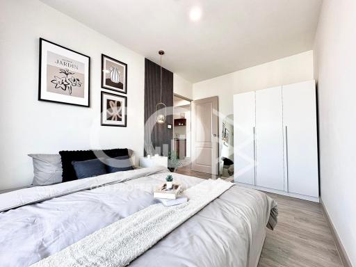 Modern bedroom interior with wooden accents, white walls, and sophisticated decor