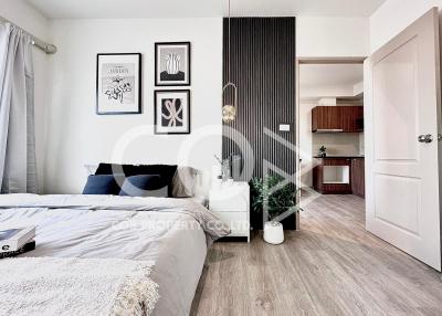 Modern bedroom with wooden floors and art decorations