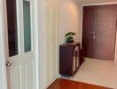 Bright hallway interior with wooden flooring and white doors