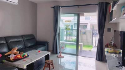 Spacious living room with modern furniture and sliding door leading to an outdoor area