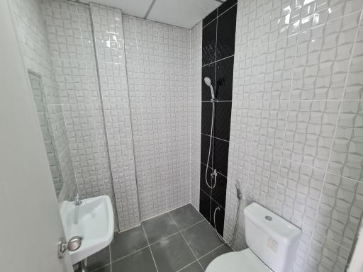 Modern bathroom with white tiles and walk-in shower