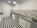 Modern kitchen with checkered floor and stainless steel sink