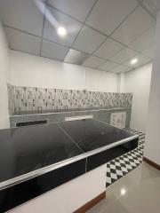 Modern kitchen with black countertops and mosaic backsplash