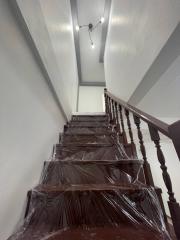 Modern staircase with protective plastic covering and LED lights