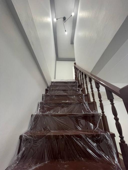 Modern staircase with protective plastic covering and LED lights