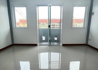 Bright empty room with glossy floor and large windows