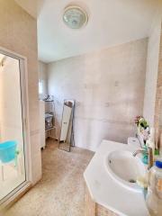 Bright bathroom with shower and tiled floors