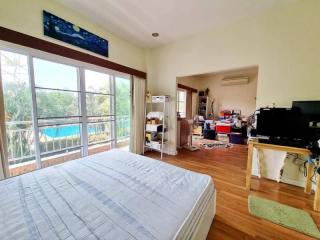 Spacious bedroom with large windows and natural light