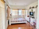 Bright and cozy bedroom with wooden flooring and modern furnishings