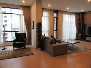 Spacious living room with natural light and modern furniture