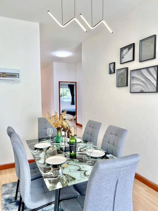 Elegant dining room with modern furnishings and wall art