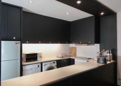 Modern kitchen with black cabinetry and stainless steel appliances