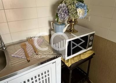 Cozy kitchen corner with decorative flowers and utensils